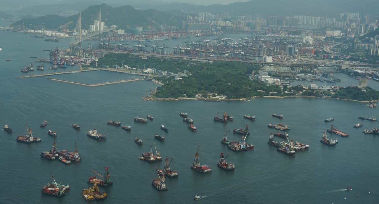 An aerial photograph of Hong Kong port and container terminals, used as a scene illustration.
